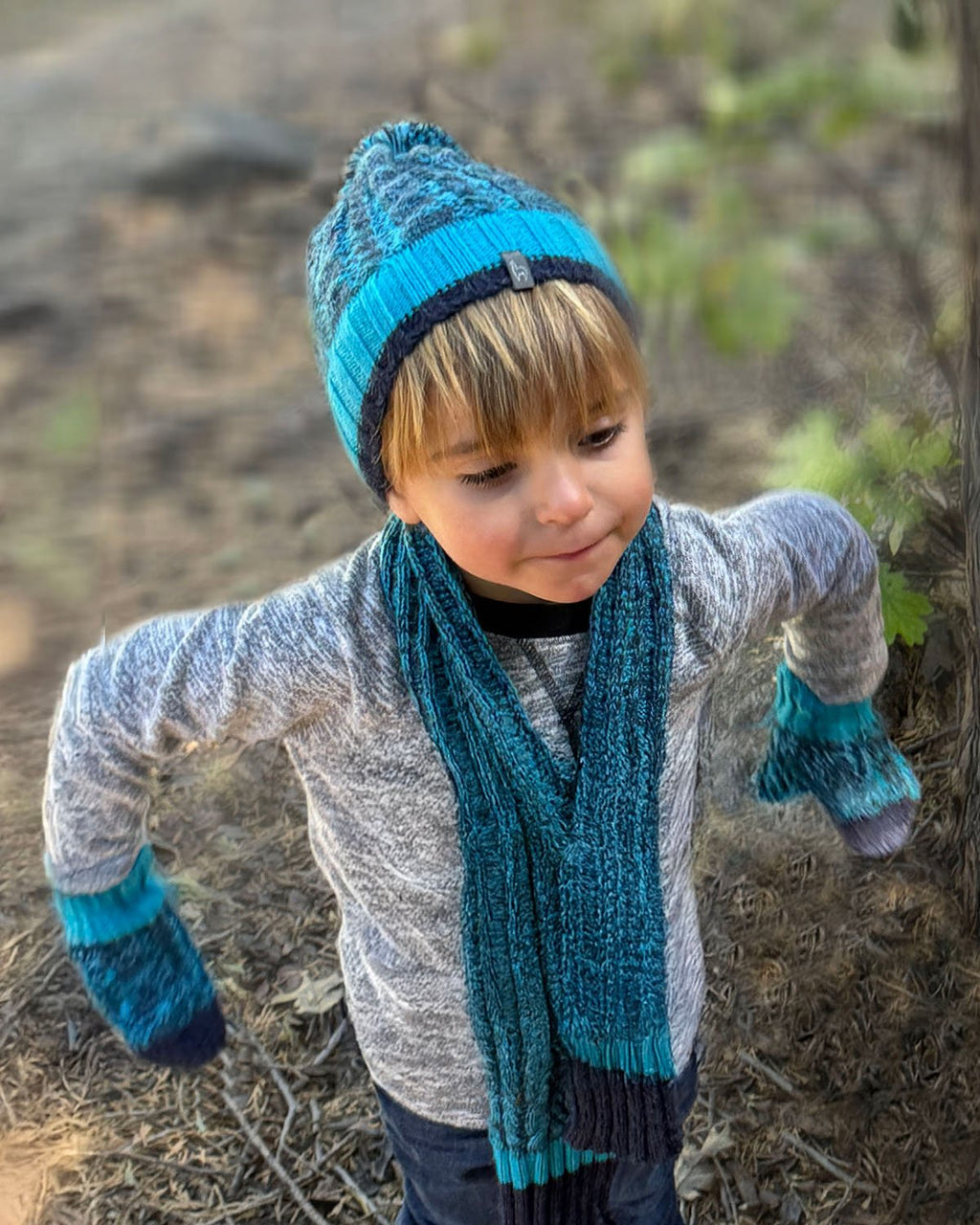 Teal kid's alpaca scarf in Blueberry Twist with aqua and navy braid, Shupaca